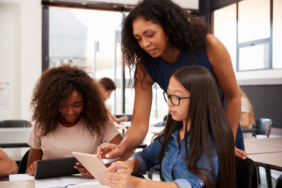 Teacher talking to two students