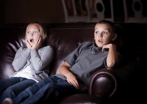 Children watching TV and frightened